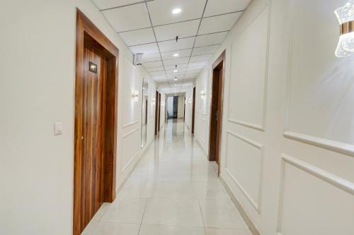 a corridor of a hospital with white walls and a long hallway at HOTEL O THE ELEGANT in Anūpnagar