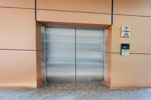 a metal door in the side of a building at HOTEL O THE ELEGANT in Anūpnagar