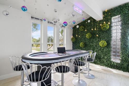 a room with a table with a laptop on it at NEW Hollywood Luxury Villa, Game Room, Hot Tub 12, Fire Pit & BBQ in Hollywood