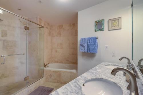 a bathroom with a shower and a sink and a tub at Capri On The Biloxi Coast in Biloxi