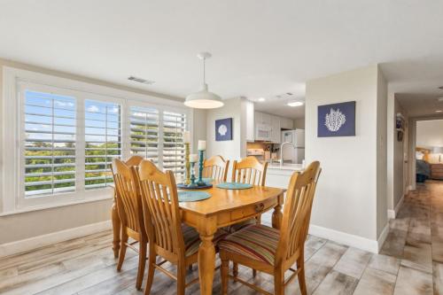 a dining room with a wooden table and chairs at Amelia Surf and Racquet Club Condo - Ocean View - 1st Floor - Pools - Tennis Courts - Sleeps 8 in Fernandina Beach