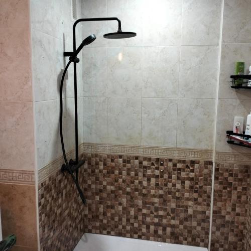 a shower with a shower head in a bathroom at Playamarina 2 Cabo Roig in Playas de Orihuela