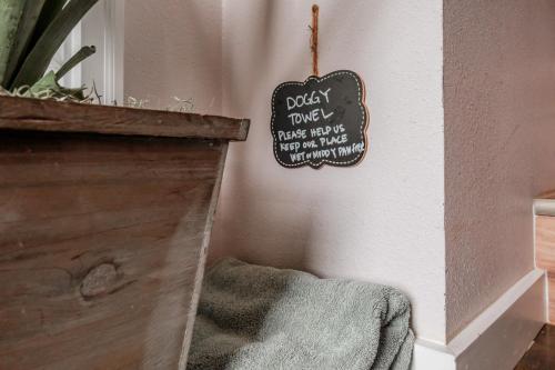 a sign hanging on a wall next to a bed at PNW Scenic Loft with Kitchenette in Philomath