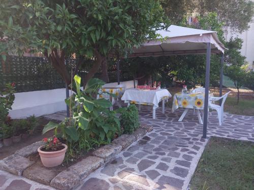 a patio with a table and an umbrella at La casa di Donato in Palinuro