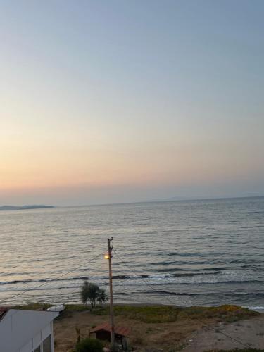 a street light next to the ocean at sunset at Leamarin in Urla