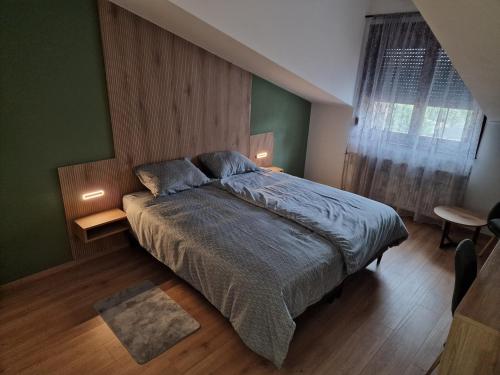 a bedroom with a large bed with green walls at Apartmani i sobe PARK in Apatin