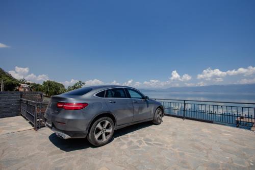 a car parked next to a body of water at Vila Kladenci in Radožda