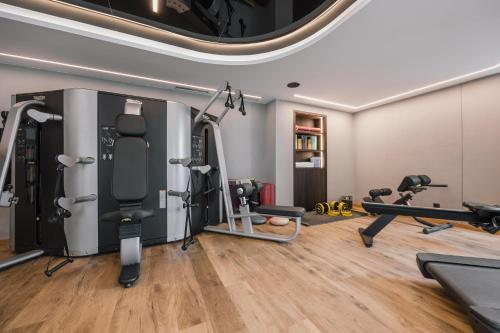 a gym with treadmills and exercise equipment at Hotel Tirol Fiss 4Sterne Superior in Fiss