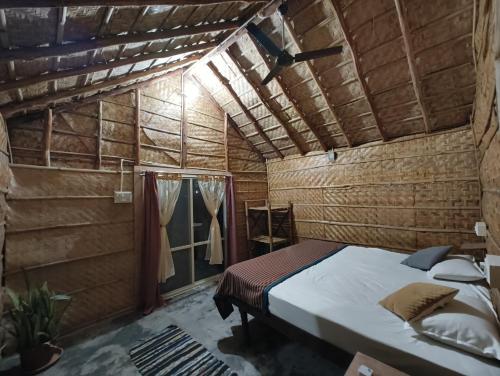 a bedroom with a bed in a wooden room at Serene Boulder in Hampi