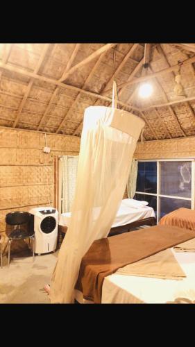 a room with a bed with a net on it at Serene Boulder in Hampi