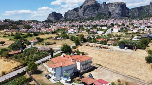 an aerial view of a city with mountains in the background at Meteora's Secret Garden House#1 in Kalabaka