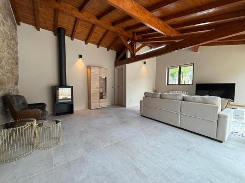 a living room with a couch and a fireplace at Cantinho da Cuca - Gerês in Terras de Bouro