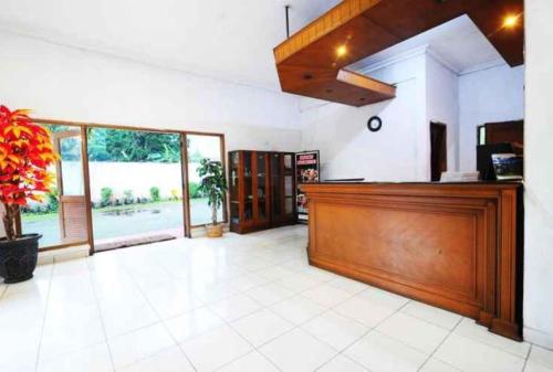 a lobby with a cash register and a large window at Graha Asri Hotel in Bandung