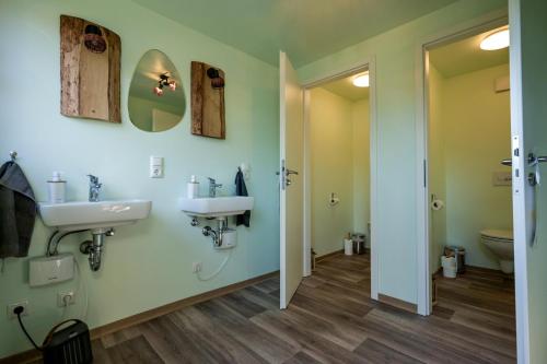 a bathroom with a sink and a toilet at Zittau - Ferienwohnung Frieda mit Camping Familien, und Biker Hütten am Zittauer Gebirge in Zittau