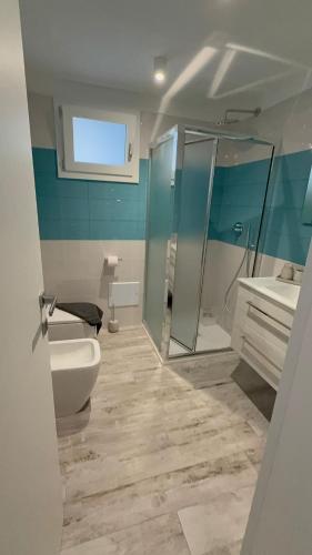 a bathroom with a toilet and a sink and a shower at DRIL Host 1 in Brindisi