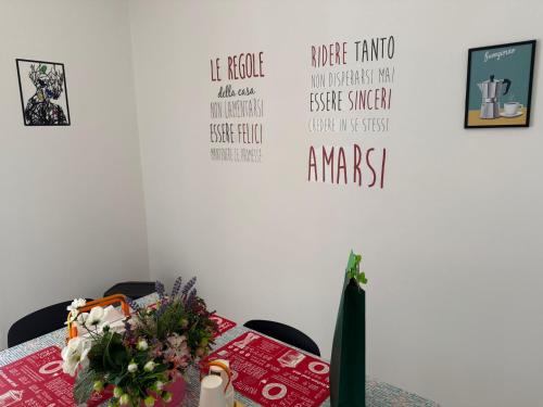 a room with a table with flowers on it at DRIL Host 1 in Brindisi