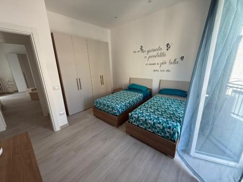 a bedroom with two beds and a wall with words at DRIL Host 1 in Brindisi