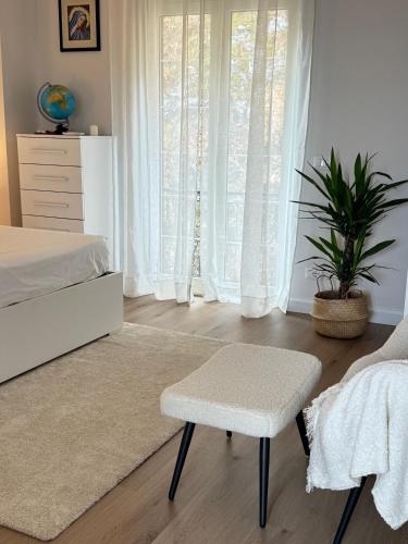 a bedroom with a bed and a chair and a window at La Terrazza Sulla Valle in Sgurgola