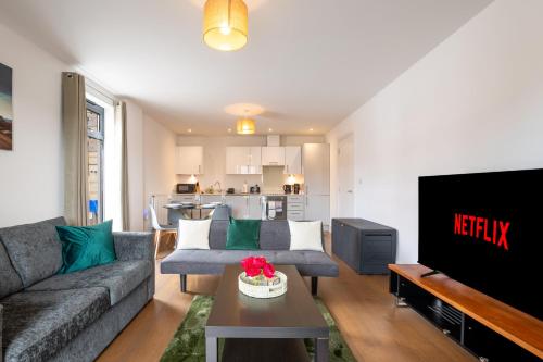 a living room with a couch and a tv at FREE fast Wi-Fi, Netflix & Large Lounge & Balcony! in Slough