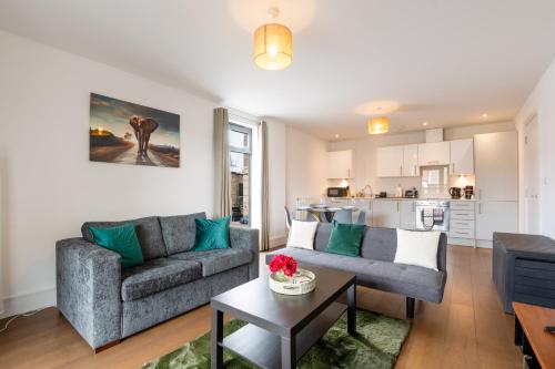 a living room with a couch and a table at FREE fast Wi-Fi, Netflix & Large Lounge & Balcony! in Slough