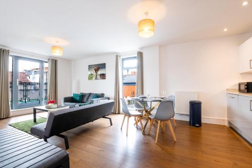 a living room with a couch and a table at FREE fast Wi-Fi, Netflix & Large Lounge & Balcony! in Slough