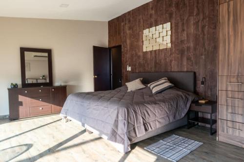 a bedroom with a bed and a dresser and a mirror at 701 Stunning Views PH private terrace apt Rooftop in Mexico City