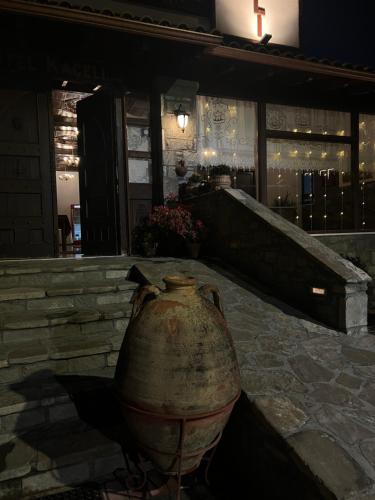 a large vase sitting in front of a building at Hotel Kaceli in Berat