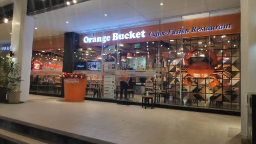 a grocery store with a large window in a mall at Palm Tree Condos across NAIA3 by Beth in Manila
