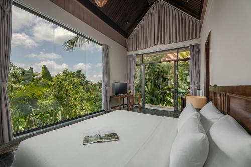 a bedroom with a bed and large windows at Coco Island Resort Ninh Binh in Ninh Binh