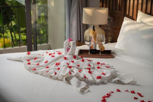 a swan made out of hearts on a bed at Coco Island Resort Ninh Binh in Ninh Binh