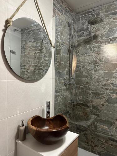 a bathroom with a wooden sink and a mirror at Casa da Forja - Gerês in Gondoriz