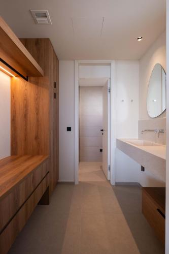 a bathroom with a sink and a mirror at Gemini Villas - Villa Calma & Siesta in Maleme