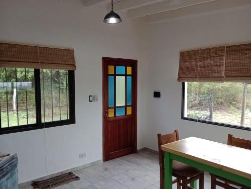 a dining room with a table and some windows at Aire de lavandas in La Paz