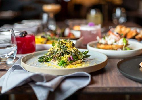 a table with plates of food on a wooden table at Sterling Inn & Spa in Niagara Falls