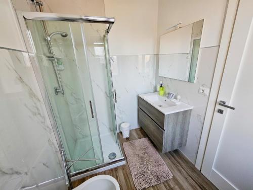 a bathroom with a shower and a sink and a toilet at B&B Al 17 in Sturno