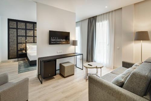 a living room with a couch and a tv at Sercotel Ayala in Bilbao