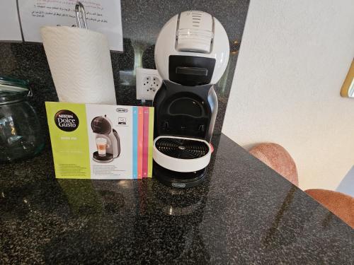 a coffee maker sitting on a counter next to a box at Habibi Apartment - Aare Jungfrau AG in Wilderswil
