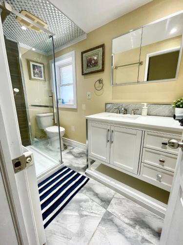a bathroom with a shower and a sink and a toilet at Bright&Modern Space Perfect for couple and Family Step to public transit in Toronto in Toronto