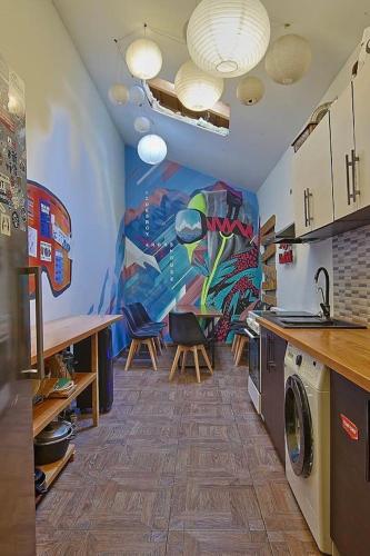a kitchen with a painting on the wall at Riders House New Gudauri in Gudauri