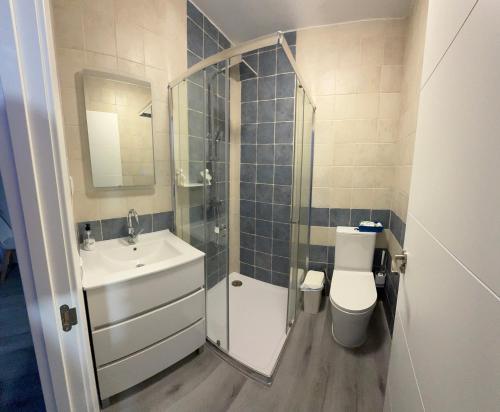 a bathroom with a sink and a toilet and a shower at La Caleya de Ozanes 