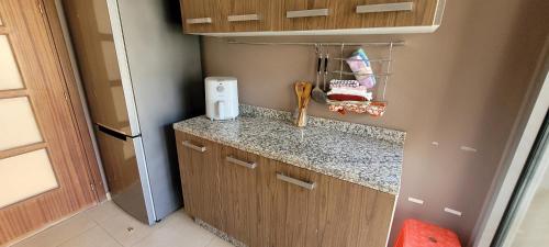 a small kitchen with a counter and a counter top at Apartment Close to Casablanca Mohamed V Airport in Nouaseur