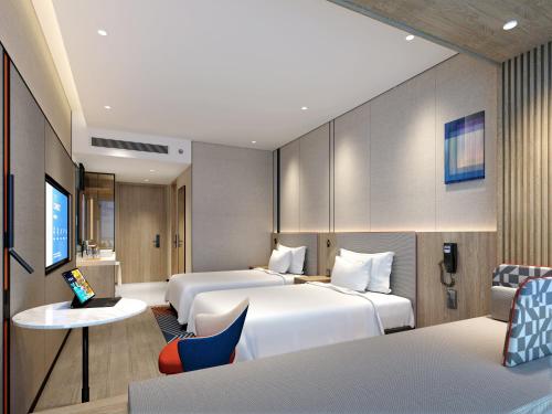 Ένα ή περισσότερα κρεβάτια σε δωμάτιο στο Holiday Inn Express Zhanjiang Coast by IHG