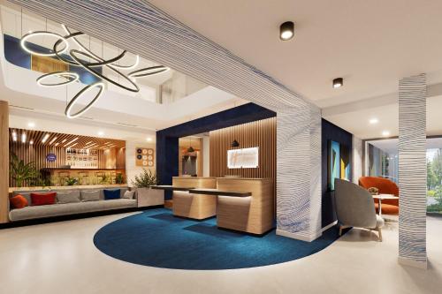 a living room with a blue rug and a chandelier at Holiday Inn Express Lublin by IHG in Lublin
