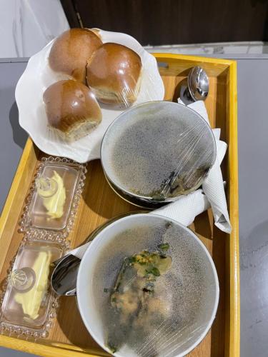 a tray of food with bread and plates of food at Morgan Hill Residence in Abuja