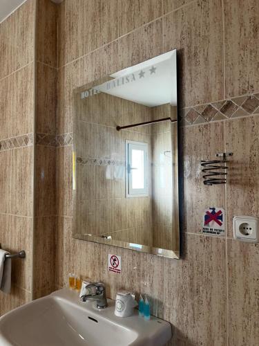 a bathroom with a sink and a mirror at Bayo Lirola Hotel Balisa in Níjar