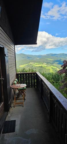 a balcony with a table and a view of the mountains at Ferienhaus Anna in Weitenbach