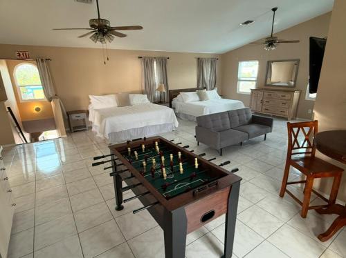 a bedroom with two beds and a chess board on a table at 4 Bedroom home with heated pool by the beach! in Clearwater Beach