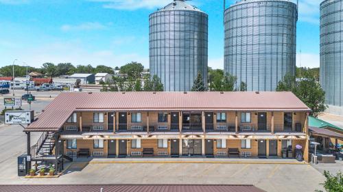 an old building with two silos in the background at Hansen Inn & Cabins in Wall