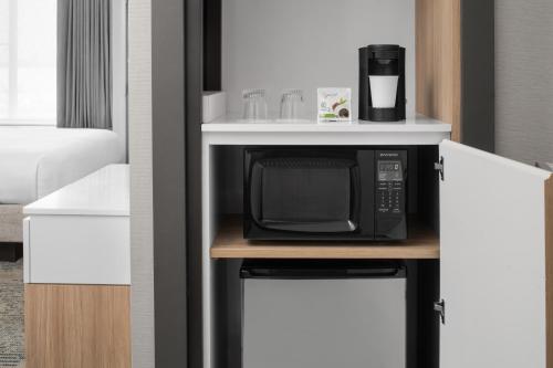 a microwave sitting on a counter in a room at SpringHill Suites by Marriott Idaho Falls in Idaho Falls