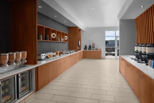 a large kitchen with wooden cabinets and a tile floor at SpringHill Suites by Marriott Idaho Falls in Idaho Falls